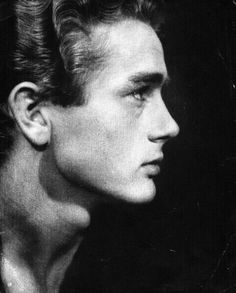 a black and white photo of a man with his hair in a high bun hairstyle