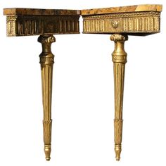 an antique console table with marble top and gold trimmings on the legs, against a white background