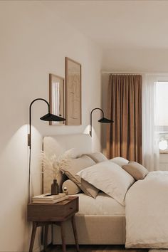 a bedroom with a bed and two lamps on the wall