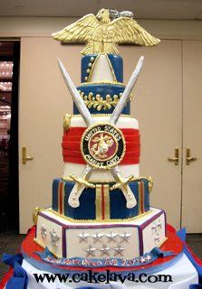 a large multi layer cake with two swords on top and an eagle above the crest