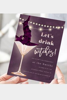 a woman holding up a card with the words let's drink witches on it