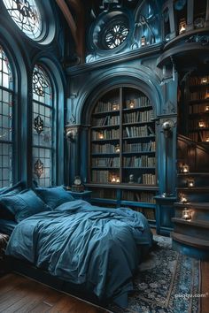 a bed sitting in front of a window next to a book shelf filled with books