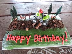 a green birthday cake with an atv and deer on it that says happy birthday to you