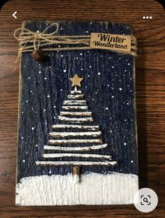 a wooden plaque with a christmas tree painted on it and the words winter wonderland written in gold