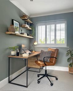 a home office with a desk, chair and shelves