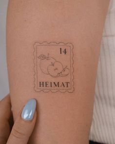 a woman's arm with a stamp on it that says, heimat