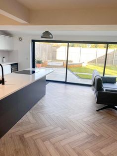 an open kitchen and living room with sliding glass doors