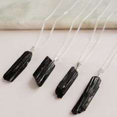 A minimalist crystal necklace featuring the powerful and beautiful black Tourmaline in its raw form as a pendant. The perfect gift for your bohemian soul. Handmade in our atelier in Paris and shipped in a carefully packed gift box. ► I T E M - D E T A I L S ◄ All our crystals come from Brazil, our beautiful home country. Our current batch of these stones is lovely, with the crystals ranging approximately 20mm of height.  > Chain is heavily plated silver 30 microns, no nickel made in Brazil and m Spiritual Black Necklace With Raw Stone, Black Tourmaline Necklace With Natural Stones, Minimalist Black Pendant Crystal Necklace, Black Healing, Pyrite Jewelry, Raw Crystal Pendant, Black Tourmaline Necklace, February Birthstone Jewelry, October Birthstone Jewelry