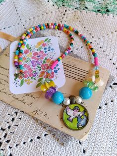 the necklace is decorated with colorful beads and bead work on it's clasp