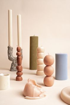 various candles and sculptures on a white surface