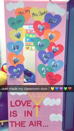 a classroom door decorated with hearts and the words love is in the air