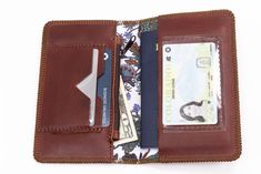 a wallet is open with money and credit cards in the front pocket on a white background