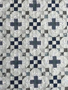 a blue and white quilt with squares on it