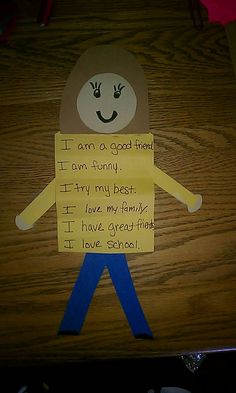 a child's handmade paper doll with words written on it and an image of a man