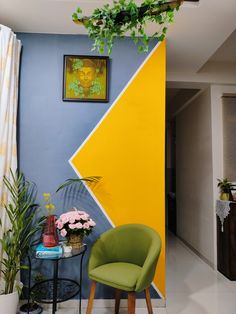 a chair and table in front of a colorful wall