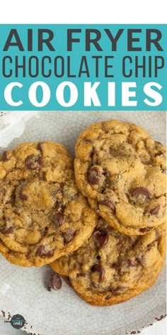 two chocolate chip cookies sitting on top of a white plate with the words air fryer chocolate chip cookies