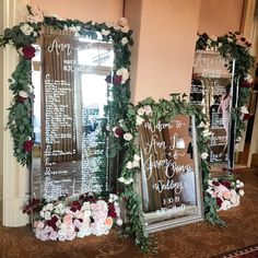 three mirrors decorated with flowers and greenery