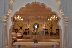 the interior of a building with columns and chandeliers