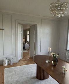 an empty room with white walls and wood flooring is seen in this image from the hallway