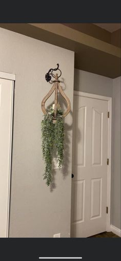 a coat rack with plants hanging from it