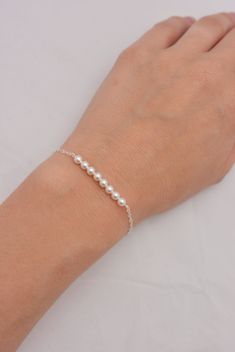 LISTING IS FOR ALL 3 STERLING SILVER BRACELETS These 3 beautiful bracelets are hand-crafted using tiny 4mm Swarovski pearls and quality sterling silver chain. Default bracelet length is 7 inches long and secures with an easy-to-use lobster clasp. Each bracelet comes in a small gift box. Pearl available in white, ivory, light pink, light grey, dark grey. IMPORTANT - PLEASE READ: Default bracelet length is 7 inches but can be made in any lengths. Please specify length(s) needed at checkout. See me Bridesmaid Pearl Bracelet, Swarovski Pearls Bracelet, Silver Pearl Bracelet, Bridesmaid Pearls, Pearl Bracelets, Large Bracelet, Bridesmaid Gifts Jewelry, Bar Bracelet, Santa Fe Nm