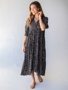 It’s no wonder that our Rebecca Midi Dress has been given over 2,000 FIVE STAR reviews! This all-time best seller is flattering for any shape and is super easy to wear. It’s fitted at the top with a buttoned bodice and a winsome empire waist. The high-low hem is ready to show off your favorite sandals, boots or heels. The rest of this tiered dress flows in a relaxed fit that keeps you comfortable in a beautiful, black cream roses print that gives it even more personality... and it has pockets! W Black Casual Tiered Midi Dress, Black Casual Tiered Dress, Casual Black Tiered Skirt Dress, Flowy Tiered Floral Dress, Casual Black Tiered Midi Dress, Black Tiered Skirt Maxi Dress With Ruffle Hem, Black Tiered Maxi Dress With Ruffle Hem, Black Tiered Midi Dress With Ruffle Hem, Flowy Empire Waist Dress With Ruffle Hem