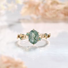 a ring with a large green stone on it