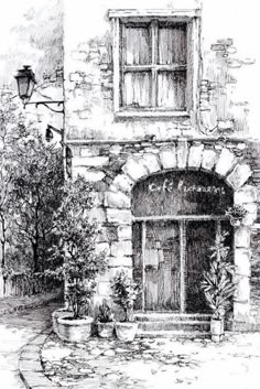 an old brick building with potted plants in front