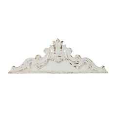 a white shelf with ornate carvings on the top and bottom, against a white background