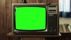 an old fashioned television with a green screen