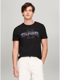 Tommy Hilfiger men's T-shirt. Made from lightweight cotton jersey, known for its breathability and stretch, our comfortable crewneck tee is cut in an easy fit and finished with our Hilfiger graphic.  Material: 100% Cotton. Tommy Hilfiger Graphic Tee For Summer, Tommy Hilfiger Graphic Tee With Letter Print, Tommy Hilfiger Graphic Tee With Crew Neck, Tommy Hilfiger Graphic Tee With Short Sleeves, Tommy Hilfiger Graphic Tee With Graphic Print, Sporty Tommy Hilfiger Tops With Graphic Print, Tommy Hilfiger Sporty T-shirt For Summer, Tommy Hilfiger Summer Graphic Tee, Tommy Hilfiger Graphic Tee For Streetwear