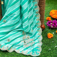 Experience the Enchantment: Elevate your style with our mesmerizing Green Leheriya Saree, a splendid fusion of tradition and opulence. This exquisite creation showcases the timeless allure of Zardozi and Aari Work, complemented by a charming scalloped border, making it a radiant addition to your wardrobe. A Timeless Addition: Ideal for weddings, special occasions, or festive celebrations, this Green Leheriya Saree with Zardozi and Aari Work is a symbol of timeless elegance and tradition. It capt Festive Pista Green Traditional Wear With Gota Work, Designer Multicolor Pre-draped Saree With Gota Work, Eid Anarkali Pre-draped Saree With Gota Work, Pista Green Sharara With Dori Work In Traditional Drape, Traditional Pista Green Wear With Gota Work, Pista Green Bollywood Traditional Wear With Gota Work, Traditional Pre-draped Saree With Dori Work For Eid, Festive Pista Green Pre-draped Saree With Gota Work, Eid Pista Green Dola Silk Pre-draped Saree