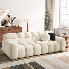 a large white couch sitting on top of a wooden floor