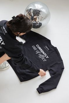 a person bending over to pick up a t - shirt with the words celebrity on it