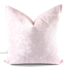 a pink pillow on a white background