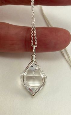 This pendant features a very clear, near perfect, 13x17 mm HERKIMER DIAMOND quartz crystal. This natural double terminated quartz crystal was hand-mined in Middleville, NY. A beautiful, A grade, crystal with great formation, and just a couple tiny imperfections (rock contact and clear inclusion). A rare and high quality stone. Total dimensions of pendant are 13x27 mm. Handcrafted with sterling silver wire (.925). You will receive this EXACT piece. Handmade in the USA. Add on a sterling silver ch Faceted Clear Crystal Necklaces As Gifts, Faceted Clear Crystal Necklace For Gift, Clear Faceted Crystal Necklace Gift, Clear Faceted Crystal Necklace For Gift, Clear Pendant Crystal Necklace In Sterling Silver, Clear Quartz Gemstone Crystals, Clear Gemstone Crystal Necklaces For Jewelry Making, Clear Quartz Crystal Necklace With Gemstone, Clear Crystal Gemstone Necklaces