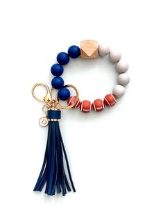 a bracelet with beads and tassels on it, including a keychain