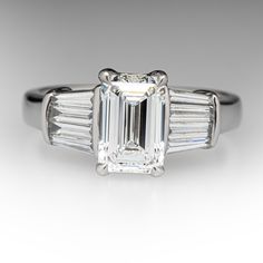 an emerald cut diamond engagement ring with baguetts