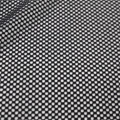 black and white checkered fabric textured with small dots on the surface, closeup