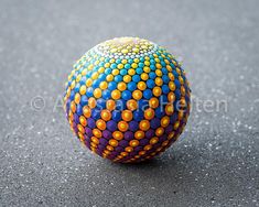 a colorful ball is sitting on the ground