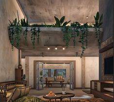 a living room filled with furniture and lots of green plants hanging from the ceiling above