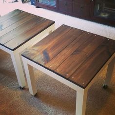 two wooden tables sitting on top of a carpeted floor