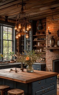 a kitchen with an island in the middle and lots of lights hanging from the ceiling