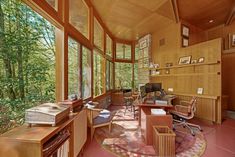 an office with wood paneling and lots of windows in the middle of the room