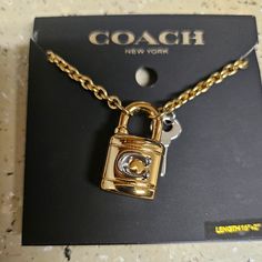 Coach Signature Padlock And Key Necklace Length: 0.5" Height: 1.0" Materials Plated Brass Features Lobster Clasp Closure Necklace: Adjustable 16" - 18" Coach Jewelry, Ar Accessories, Cell Phone Holster, Coach New York, Phone Holster, Key Necklace, Jewelry Lookbook, Walker Boots, Dream Jewelry