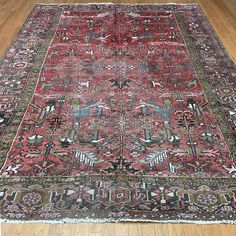 an antique persian rug is laying on the floor in a room with wooden floors and hard wood floors