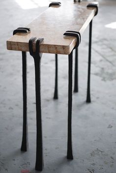 three wooden benches with metal legs on concrete floor