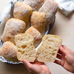 a person is holding some bread in their hand and it looks like they are going to eat them