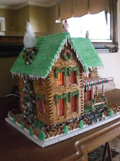 a gingerbread house is decorated for christmas