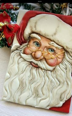 a ceramic santa clause with glasses and beard